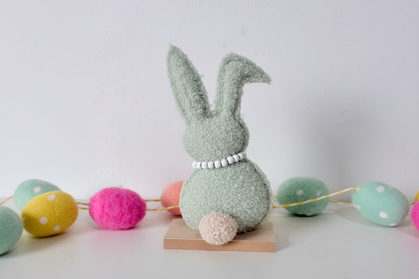 Green and Brown Rabbit on wooden base
