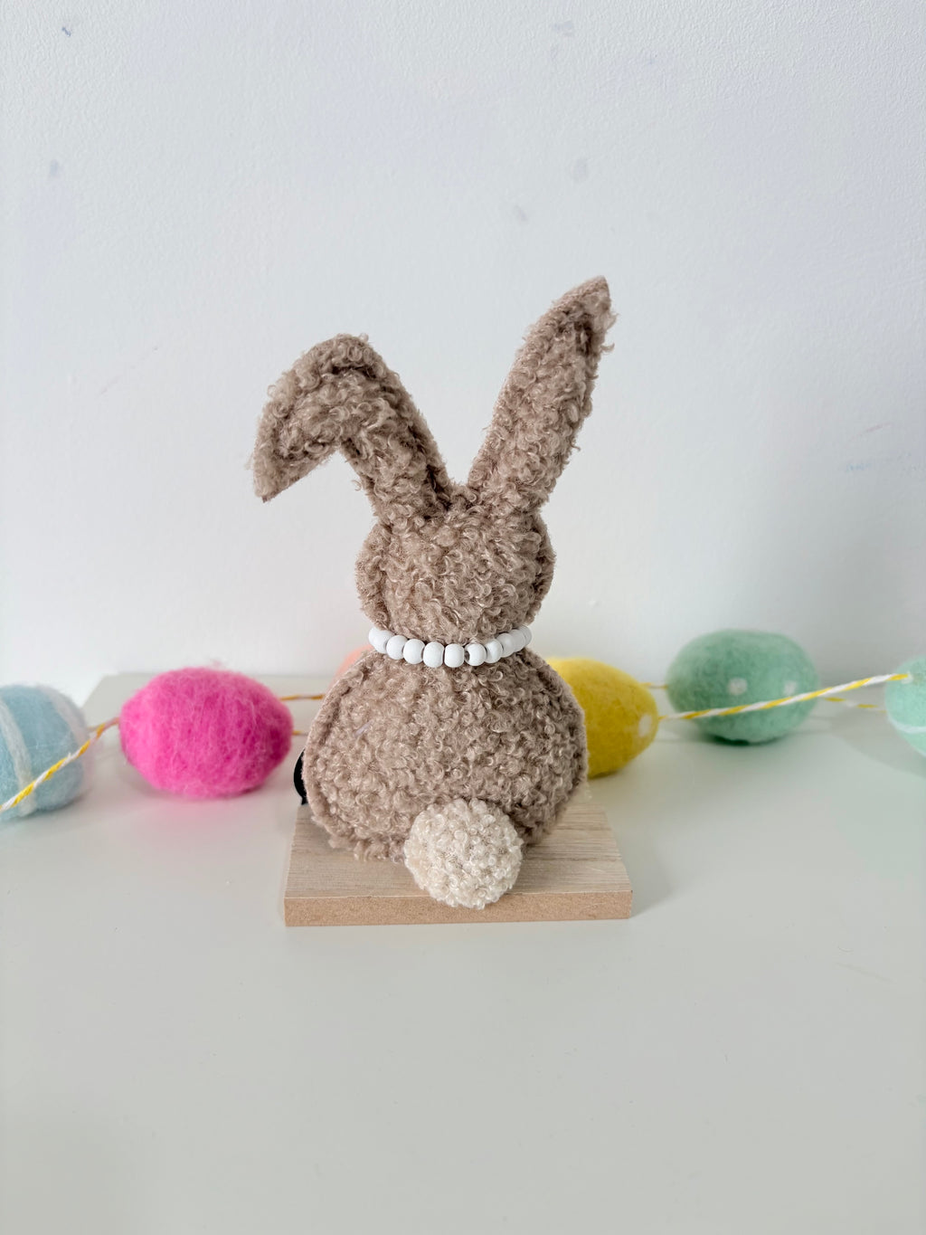 Green and Brown Rabbit on wooden base