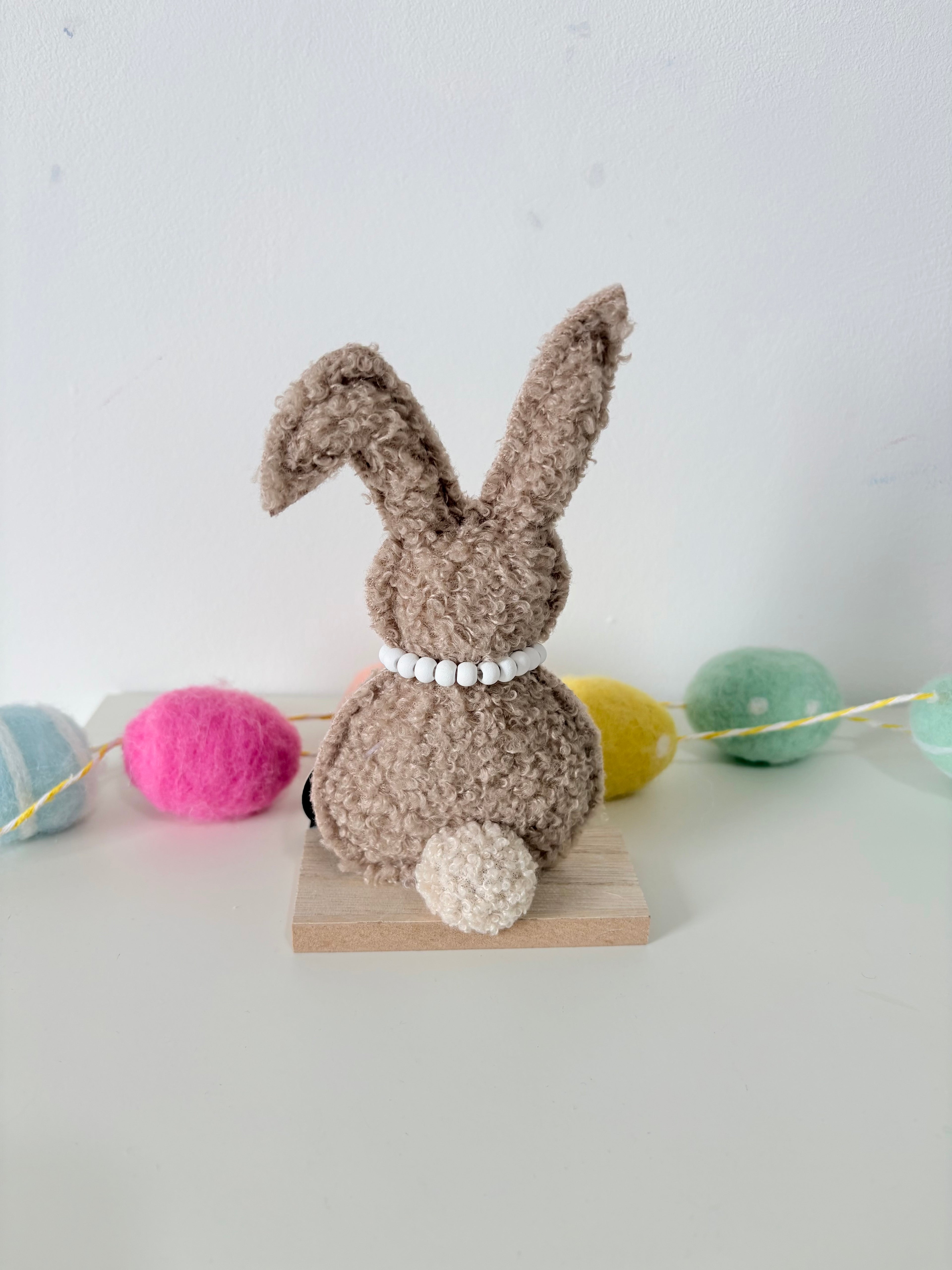 Green and Brown Rabbit on wooden base